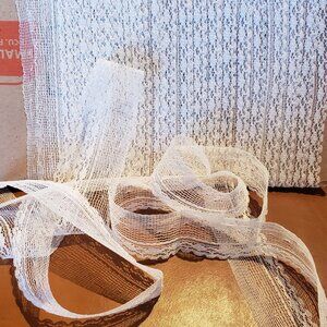 White scalloped lace trim.  1/2" wide with Leader edge - 9 yards.